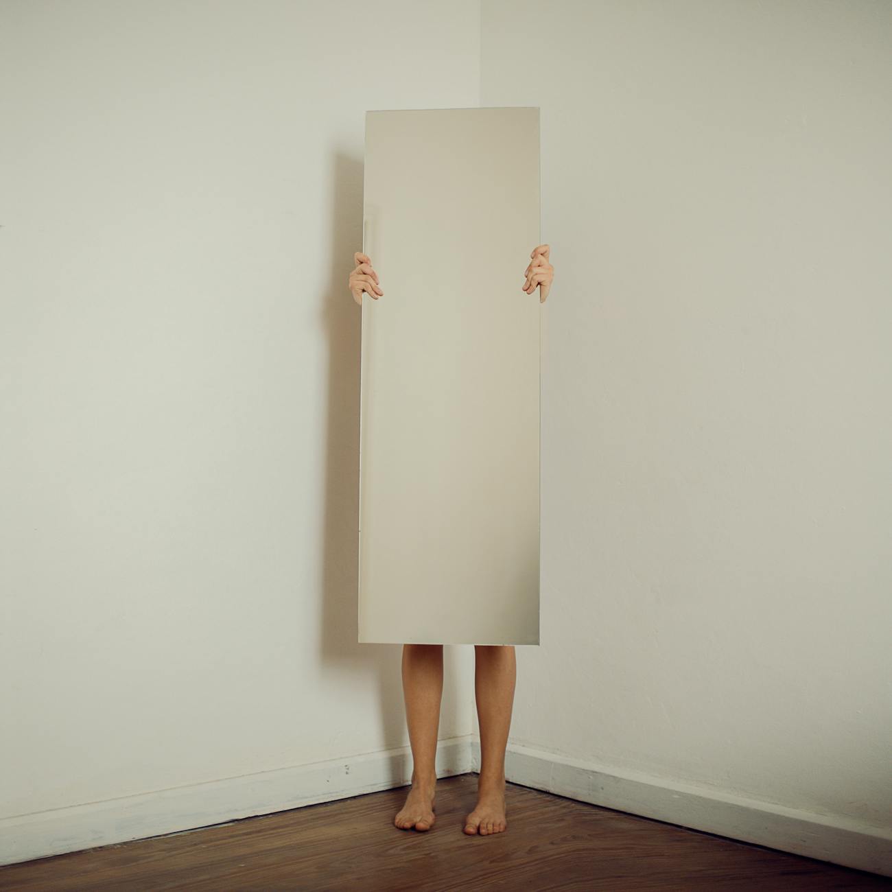 woman behind a mirror in a room